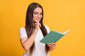 Sticker - Photo of smart charming minded woman hold hand chin book novel isolated on shine yellow color background