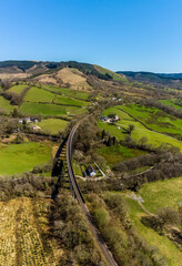 Wall Mural - The Victorian railway viaduct casts a shadow on the valley floor at Cynghordy, Carmarthenshire, South Wales on a sunny day