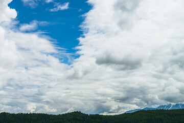 Wall Mural - scenic nature landscape with beautiful clouds in blue sky. colorful cloudscape with clouds above sno