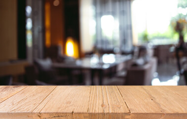 Empty wooden table in front of abstract blurred background of coffee shop . can be used for display or montage your products.Mock up for display of product