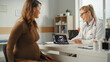 © Gorodenkoff - Female Physician Showing Tablet Computer with Ultrasound Pregnancy Scan to Young Future Mother Patient During Consultation in a Health Clinic. Family Doctor Sitting Behind a Desk in Hospital Office.