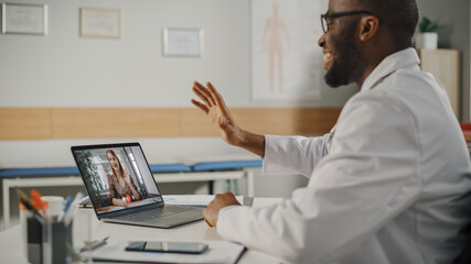 Wall Mural - Doctor's Online Medical Consultation: Black Handsome Physician is Making a Video Call with a Female Patient on Laptop Computer. Health Care Professional Giving Advice, Explaining Test Results.