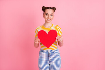 Poster - Portrait of pretty positive lady hands hold paper heart symbol card toothy smile isolated on pink color background