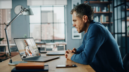 Aufkleber - Handsome Caucasian Man Having a Video Call with Male Doctor on Laptop Computer while Sitting Behind Desk in Living Room. Freelancer Working From Home and Talking a Medic Over the Internet.