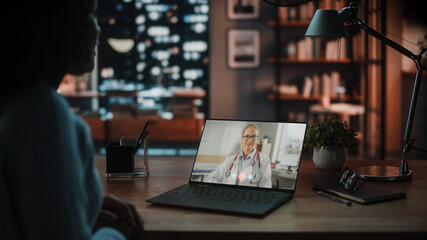 Fototapete - Over the Shoulder Shot of a Female Using Laptop for a Video Call to a Beautiful Caucasian Female Doctor at Home Living Room. Healthcare Specialist Talks About Good Test Results Over the Internet.