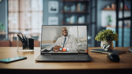 Aufkleber - Laptop Computer with Video Call to a Male Doctor Standing on the Table in Cozy Living Room. In the Background Stylish Modern Bright Home Office Studio During Day with Big Cityscape Window.