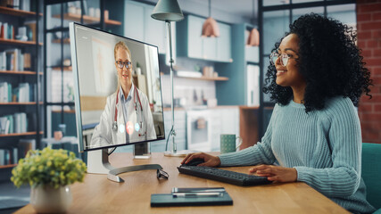 Aufkleber - Handsome Latin Female is Making a Video Call to Her Medical Consultant on Desktop Computer at Home Living Room while Sitting at Table. Woman Working From Home and Talking to a Doctor Over the Internet