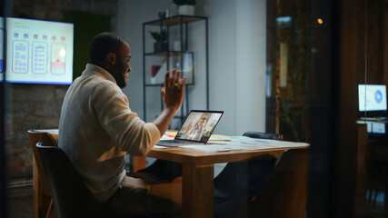 Poster - Handsome Black African American Project Manager is Making a Video Call to a Doctor on Laptop in a Creative Office Environment. Man is Talking to His Medical Consultant Over a Live Camera.