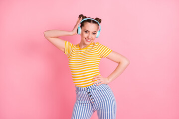 Canvas Print - Portrait of adorable person put hand on waist touch headphones toothy smile isolated on pink color background