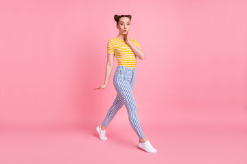 Sticker - Full size photo of impressed brunette lady go hand face wear yellow t-shirt pants sneakers isolated on pink color background