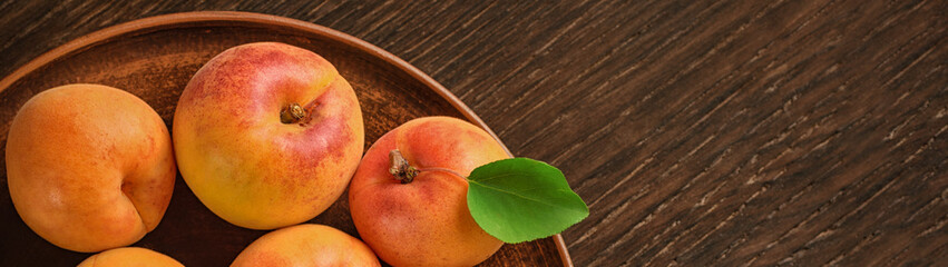 Wall Mural - Harvest appetizing apricot in bowl with free space for text