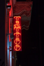 Close-up On A Red Neon Light Shaped Into The Word "Tattoo".