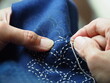 © Ben - Close up needle in woman's hands sewing running stitch in blue fabric. Traditional Japanese sewing pattern call 'SASHIKO'.Japanese embroidery, learning ,teaching,how to do, hand craft ,hobby concept.