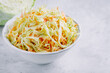 © NBLX - Traditional coleslaw salad with fresh sliced carrots and cabbage in a white bowl