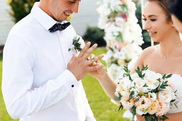 Happy newlyweds at an outdoor ceremony. Wedding day