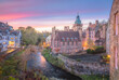 Vibrant, colourful sunset or sunrise sky over the historic quaint architecture of Dean Village along the Water of Leith in Edinburgh, Scotland.