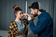 © Srdjan - Young couple arguing a man with his hand pint a finger in her face threaten a woman, domestic violence and abuse concept