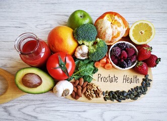 Wall Mural - Super foods for healthy prostate. Natural products to prevent prostate cancer and boost prostate health. Apple, tomato, tomato juice, nuts, strawberry, grapefruit, spinach, lemon, oranges, garlic, etc