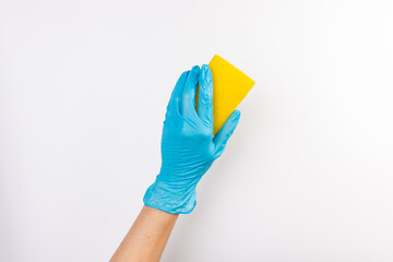 Sponge for washing dishes in female hand. Hand in a latex glove. Woman's hand gesture or sign isolated on white. A hand in a glove holds a sponge for washing and cleaning dishes