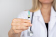 © eda - Young nurse or doctor holding syringe with new vaccine. Close-up of a vaccine medical syringe.