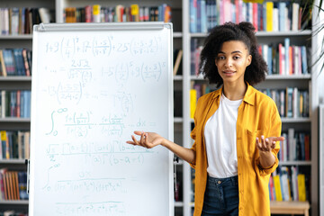 portrait friendly young woman, african american female teacher, standing near whiteboard, in stylish
