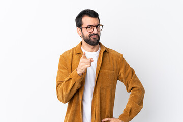 Wall Mural - Caucasian handsome man with beard wearing a corduroy jacket over isolated white background frustrated and pointing to the front