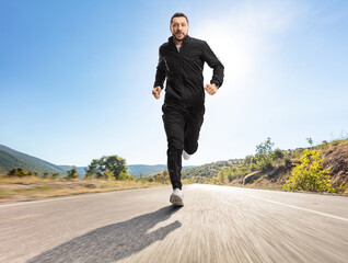 Sticker - Man in black tracksuits running outdoors on an asphalt road