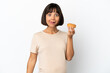 © luismolinero - Young mixed race pregnant woman isolated on white background holding a donut