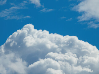 White fluffy cumulus clouds on a blue sky