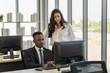 © Montri Thipsorn - Diversity Business and Team Work concept. African businessman and businesswoman team colleague working  with desktop computer in office.