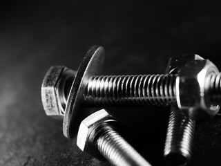 Canvas Print - Closeup shot of metal screw threads isolated on the black background