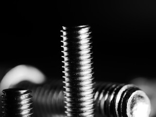 Canvas Print - Closeup shot of metal screw threads isolated on the black background