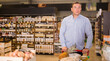 © JackF - Adult man with shopping cart chooses vegetables and fruits in the store. High quality photo