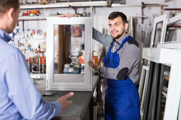 Production workers in coverall with different PVC windows and doors