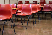 Old Style Red Empty Plastic Chairs In Lecture Room