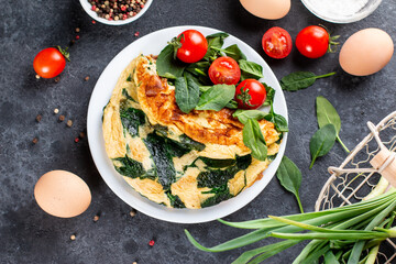 Wall Mural - Omelet with spinach leaves, diet food, omelette on plate, morning breakfast. Top view.