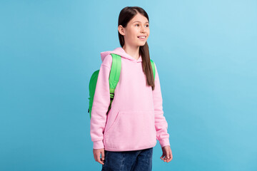 Poster - Portrait of attractive cheerful dreamy girl going to secondary school isolated over bright blue color background