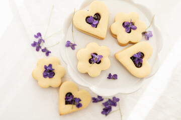 Wall Mural - selection of sweet baked cream edible flowers and fruit dessert cakes for mothersday, wedding, birthday, paerty celebration. viola odorata cake. 