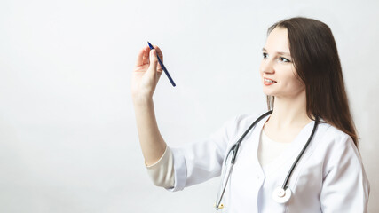 Wall Mural - woman doctor writes something in the air with a pen close up