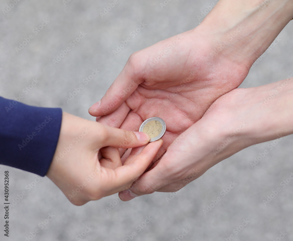 hand of the young woman while giving alms to the poor boy Stock Photo |  Adobe Stock, image size:1000x825