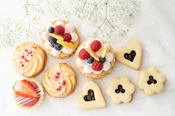 Wall Mural - selection of sweet baked cream edible flowers and fruit dessert cakes for mothersday, wedding, birthday, paerty celebration. viola odorata cake. 