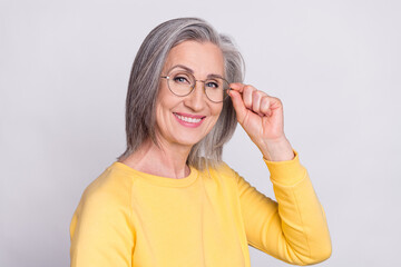 Sticker - Photo of mature cool smiling cheerful positive woman in glasses wear yellow sweater isolated on grey color background