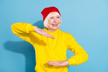 Sticker - Photo of dreamy happy nice old woman look empty space dance funky isolated on pastel blue color background