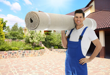 Wall Mural - Worker with rolled carpet outdoors on sunny day