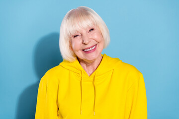 Canvas Print - Photo of cheerful nice positive old woman smile good mood modern lady isolated on blue color background