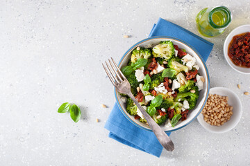 Wall Mural - healthy broccoli salad with feta cheese sun dried tomatoes pine nuts.. vegetarian low carb keto diet