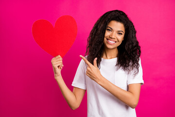 Sticker - Photo of lovely brunette young lady point heart wear white t-shirt isolated on pink color background