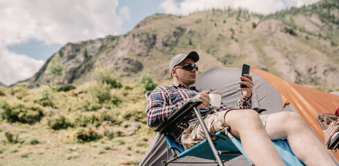 Poster - drinking coffee and using smart phone outdoors