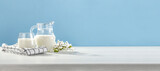 Fresh milk on white desk and blue background. 