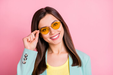 Wall Mural - Photo portrait of cool pretty girl wearing glasses isolated on pastel pink colored background